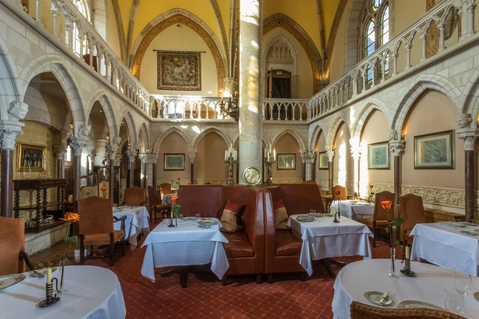 The main dining room of the Abbaye de la Bussière restaurant is historically preserved, with its all-stone cloister.
